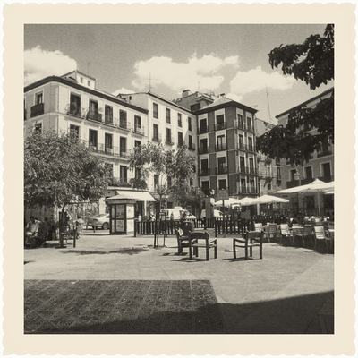 Reflex Twin: café tables on a town square, warm black-and-white square