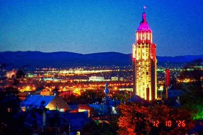 Kompakt LC: a city clock tower at dusk, saturated blues and pinks