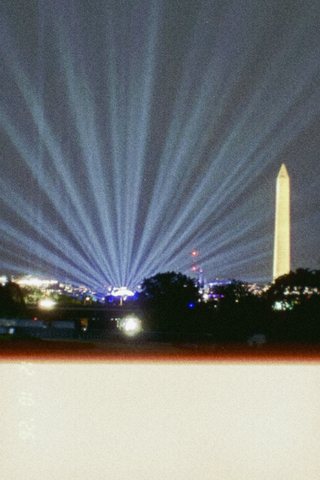 A dark, murky night shot of searchlights